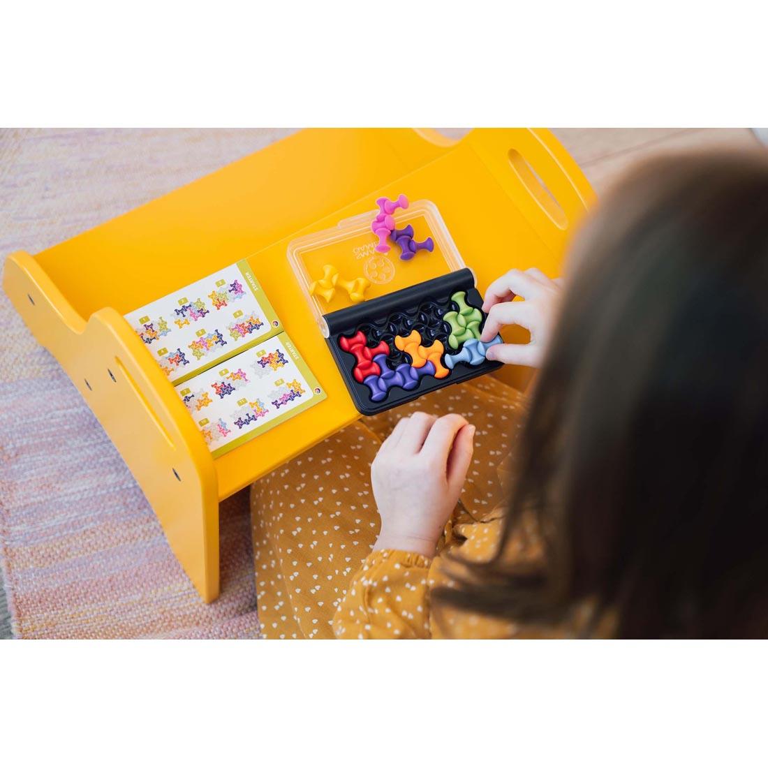 child playing the IQ Waves Puzzle Game By Smart Games
