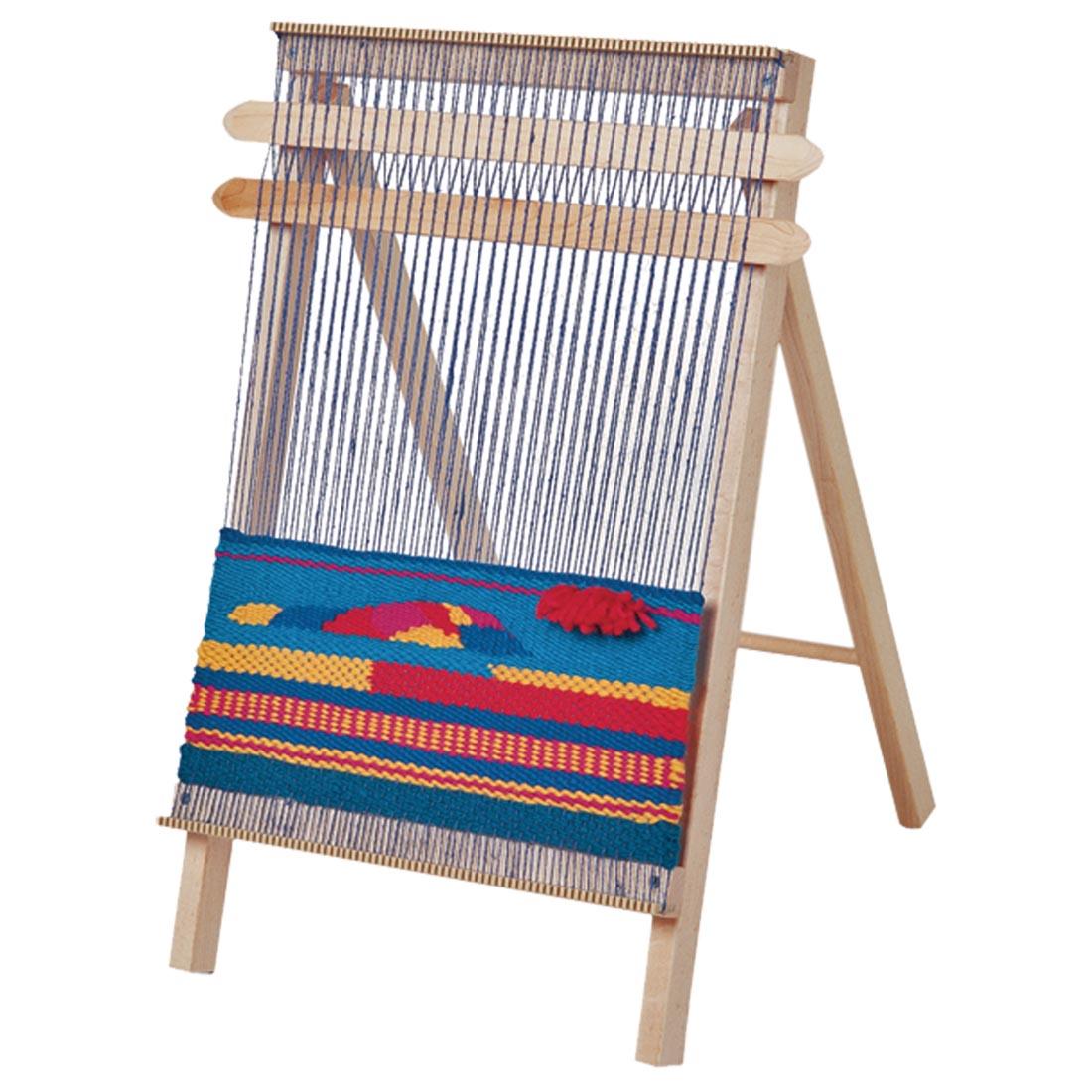 Schacht Spindle Co. School Loom shown with a weaving project started