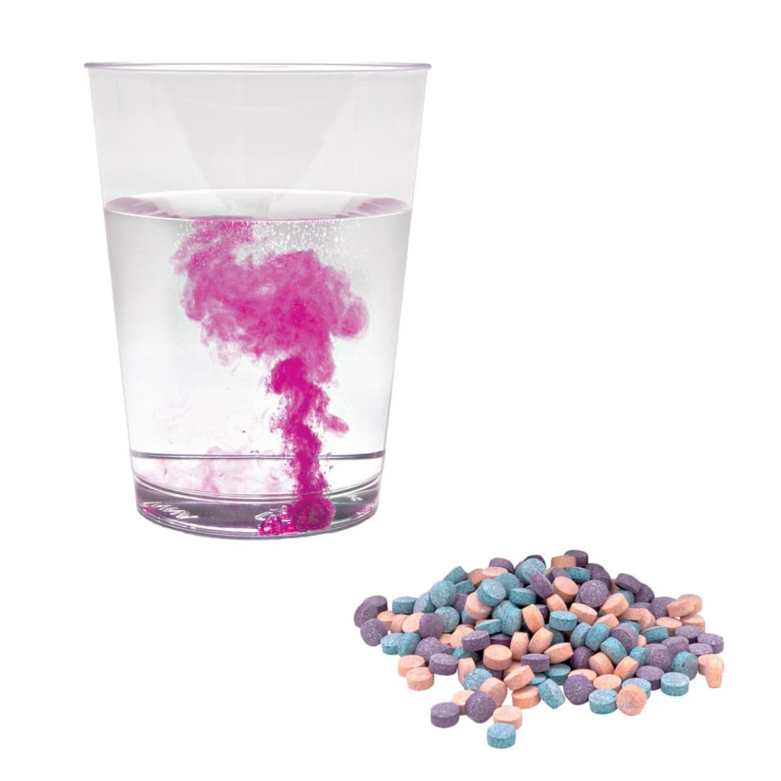 Glass of water with a Color Fizzing Tablet in it and more tablets in a pile beside it
