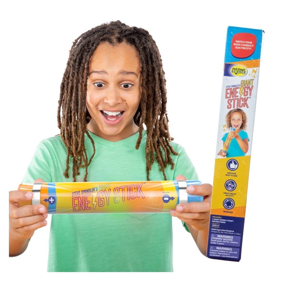 Child holding a Giant Energy Stick By Steve Spangler Science with a packaged one beside