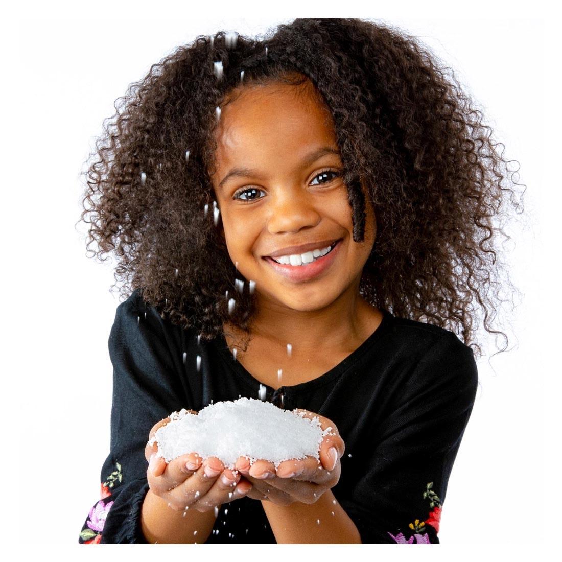 Child holding snow from the Insta-Snow Powder Tube By Steve Spangler Science