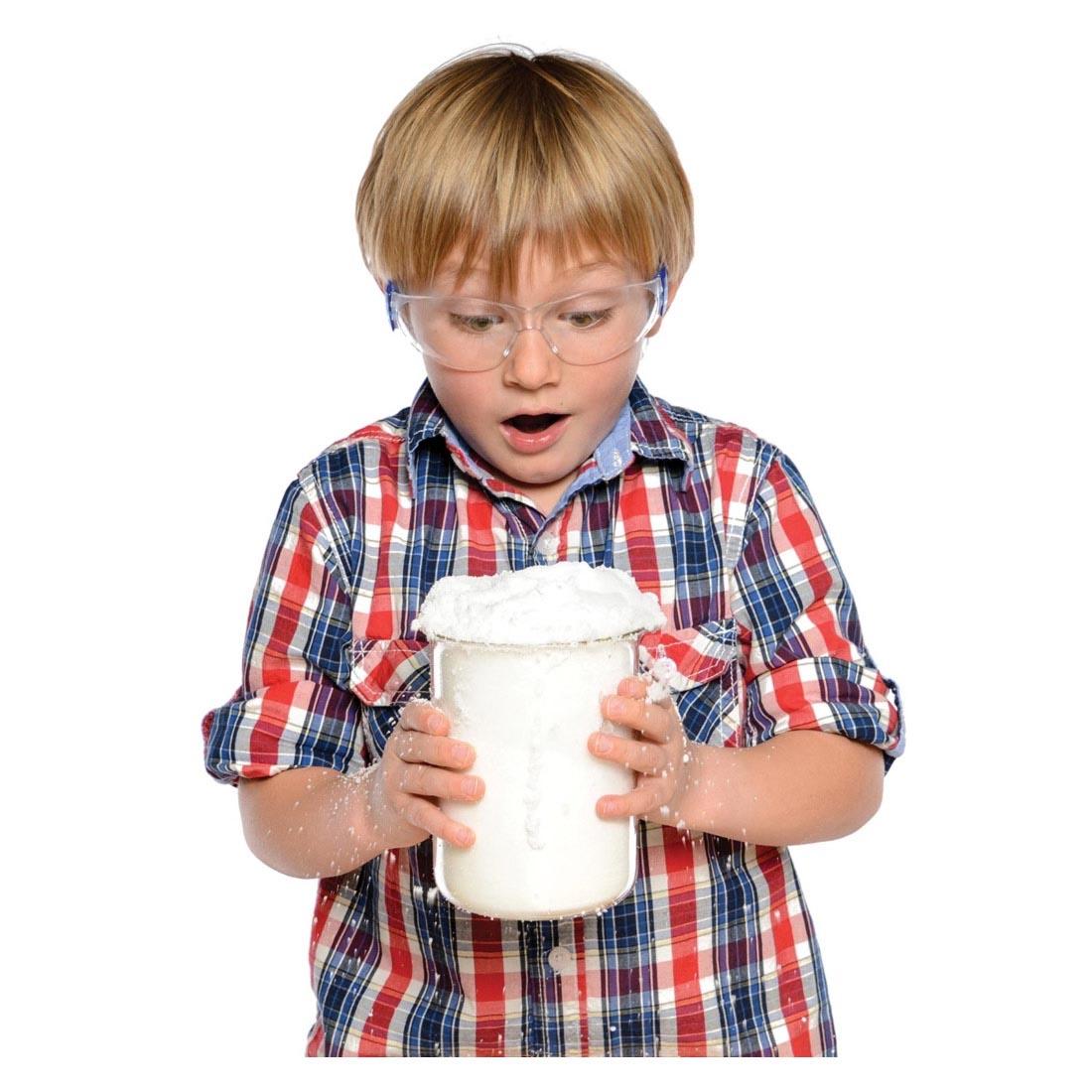 Child holding snow from the Insta-Snow Powder Pouch By Steve Spangler Science