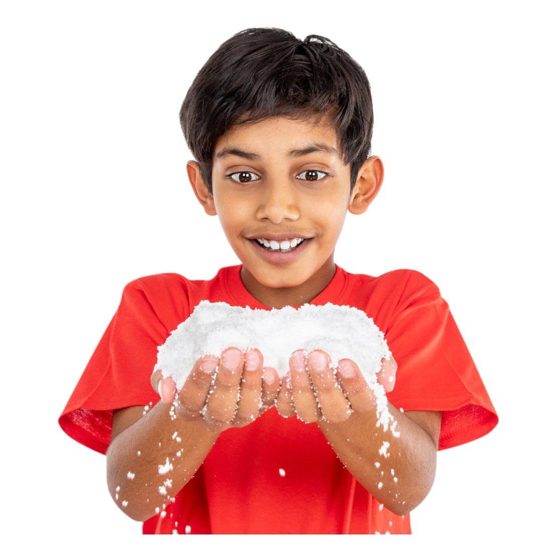 Child holding snow from the Snowman Science Kit By Steve Spangler Science