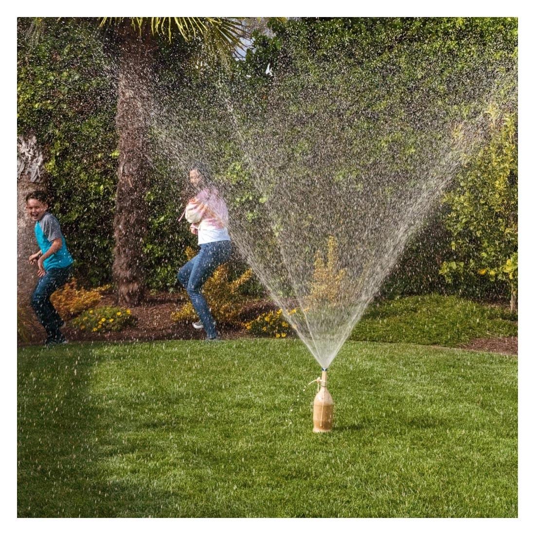 People in a yard watching cola erupt by using the Extreme Geyser Tube Set By Steve Spangler Science