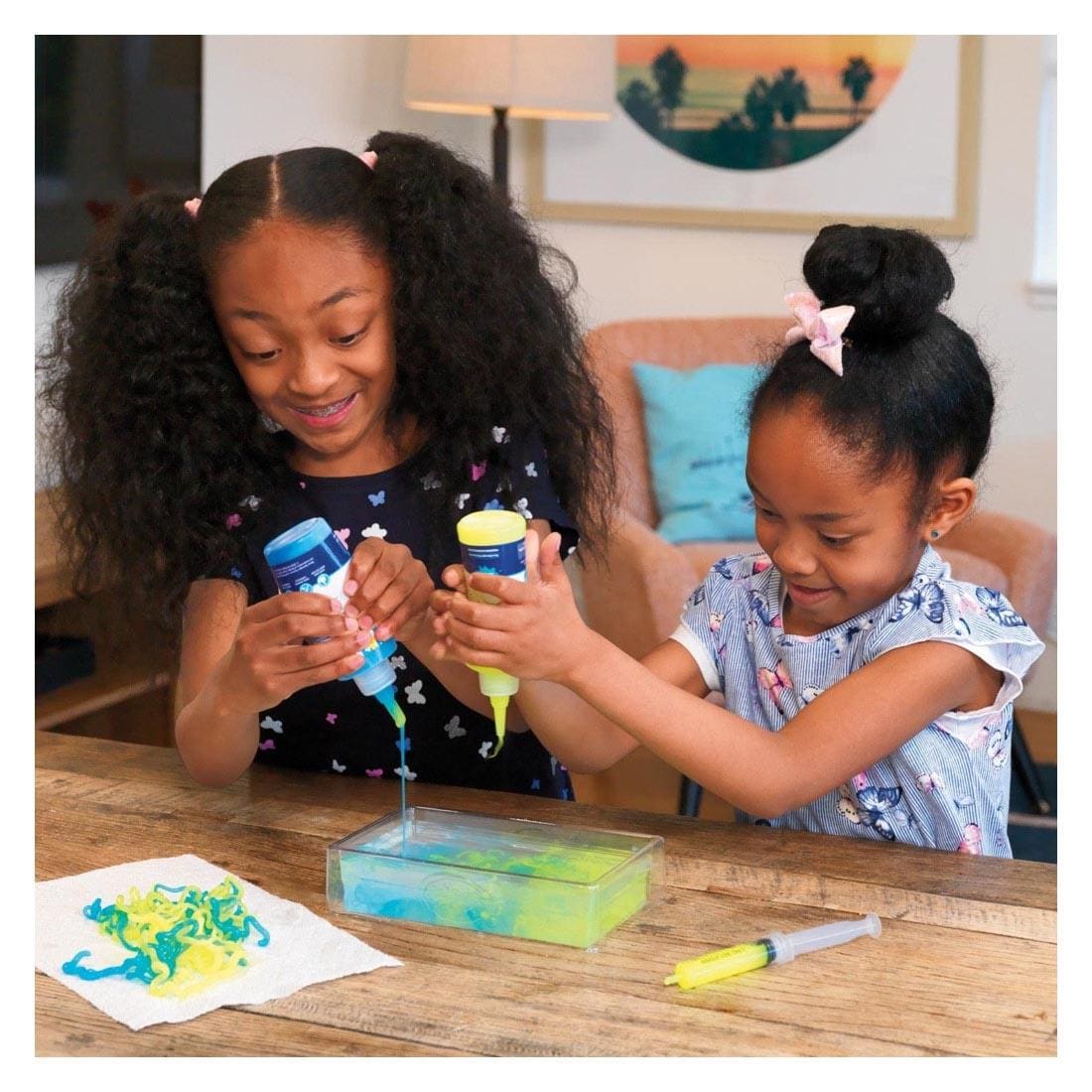 Two children playing with the String Slime Starter Set By Steve Spangler Science