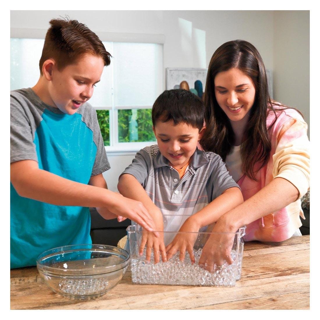 Adult and two children playing with the Jelly Marbles By Steve Spangler Science