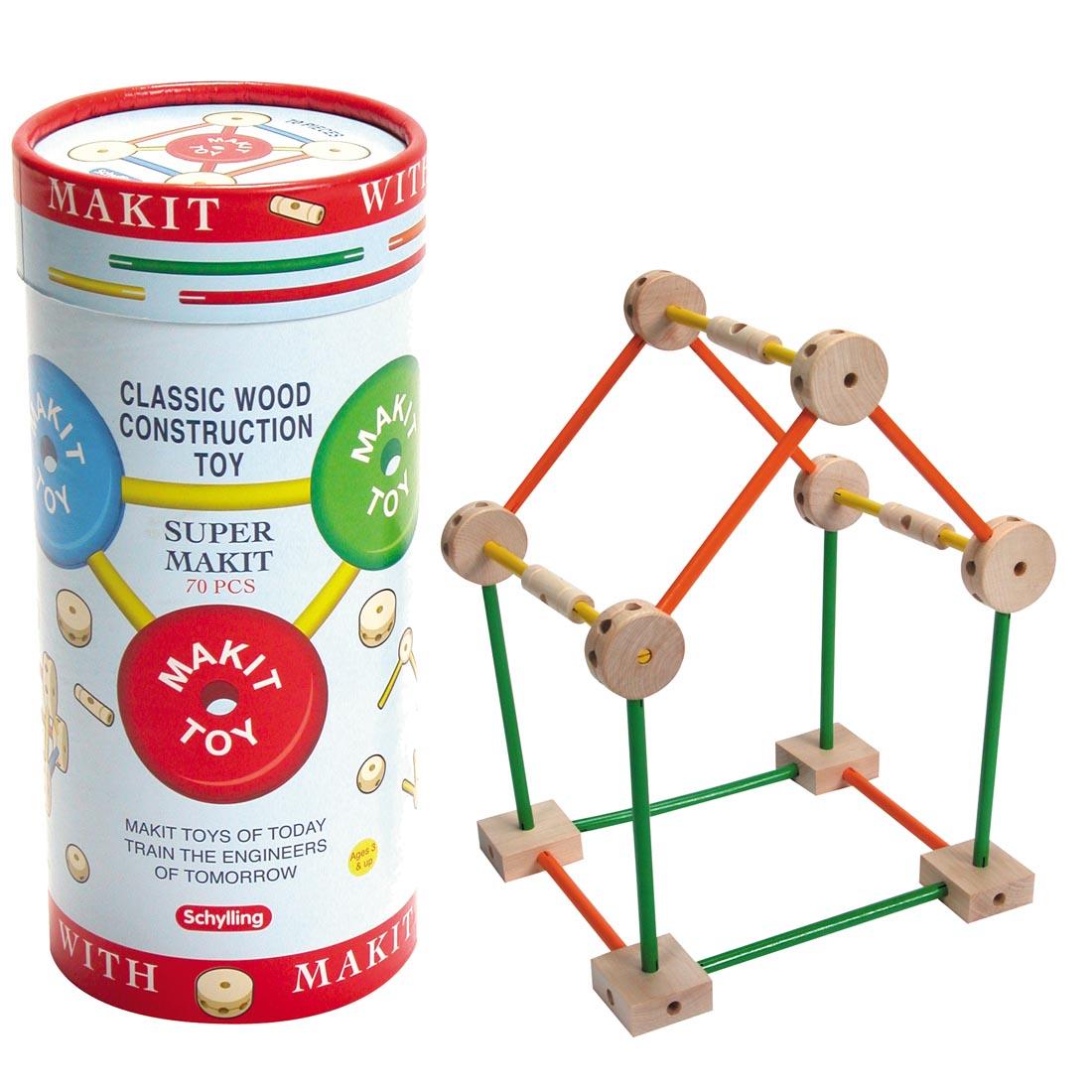 Super Makit Classic Wood Construction Toy Package beside a structure built with the pieces