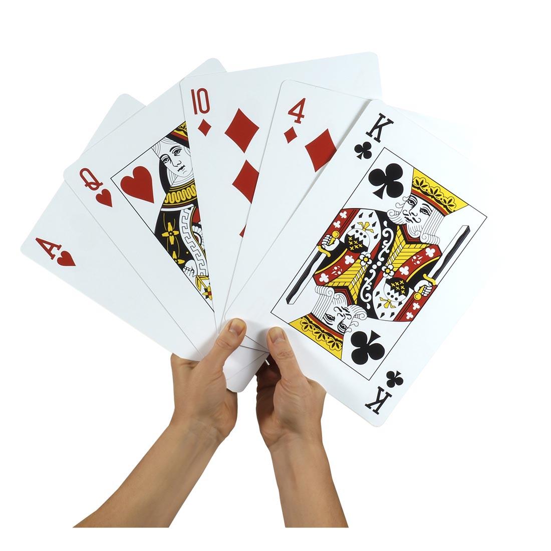 Hands holding five Jumbo Playing Cards