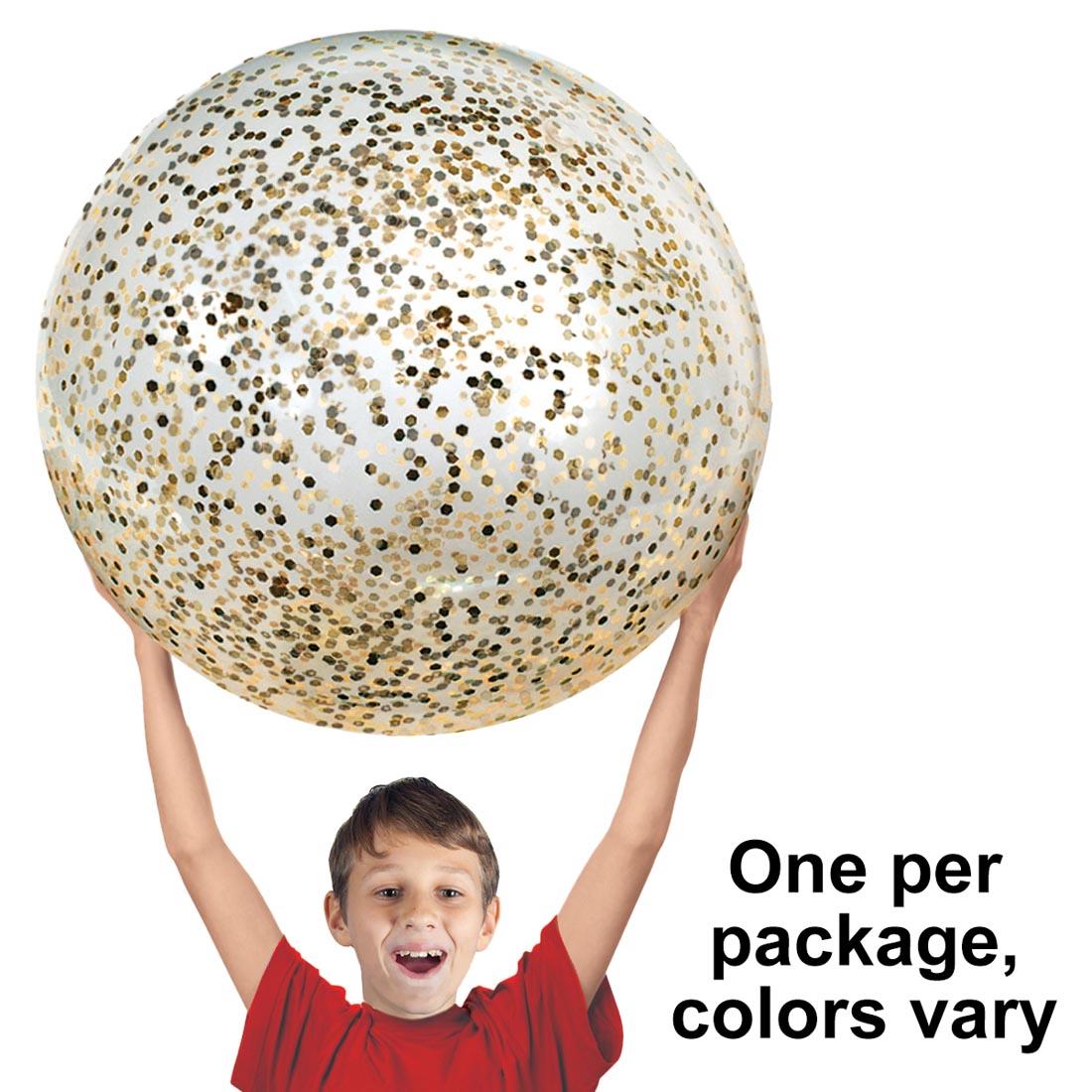 child holding a Glitter Jumbo Jelly Ball over their head with the text One per package, colors vary