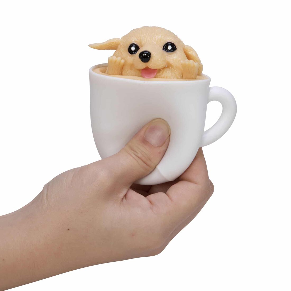 Hand squeezing a Pup In A Cup Squishy Toy By Schylling Toys