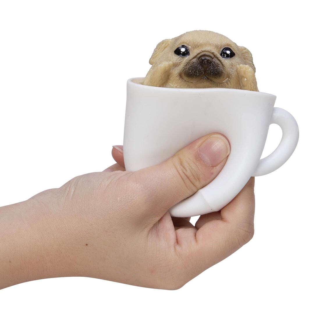 Hand squeezing a Pup In A Cup Squishy Toy By Schylling Toys