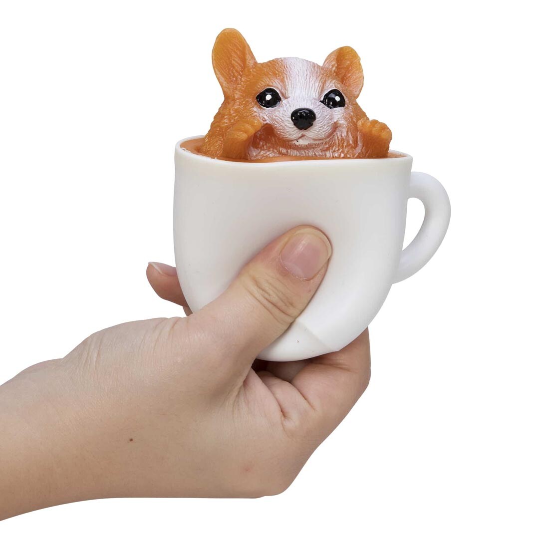 Hand squeezing a Pup In A Cup Squishy Toy By Schylling Toys