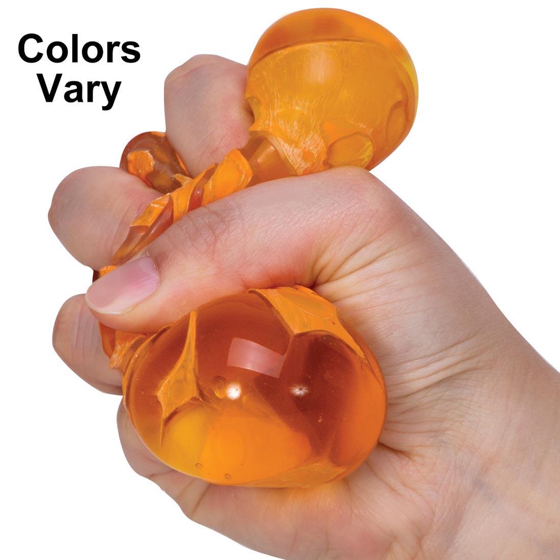 Hand squeezing a Magma Light Up Squeeze Ball and the text Colors Vary