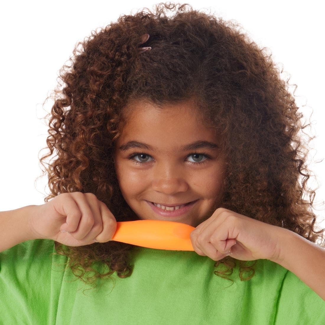 child stretching a Teenie Nee Doh Rainboh ball between two hands