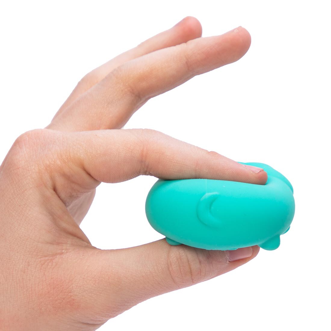 Hand shown squishing a Teenie Nee Doh Funky Pup with thumb and forefinger