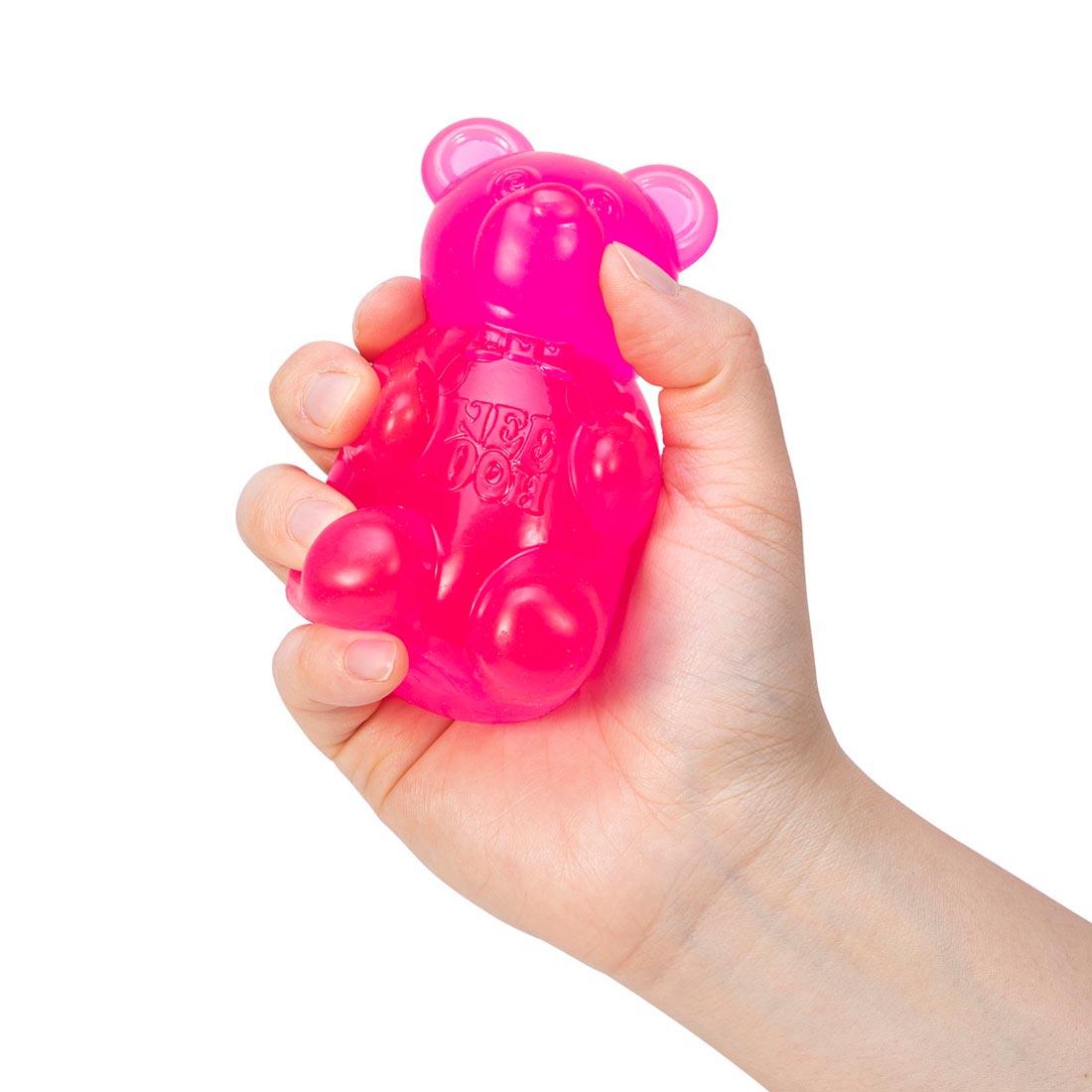 hand holding a pink Nee Doh Gummy Bear