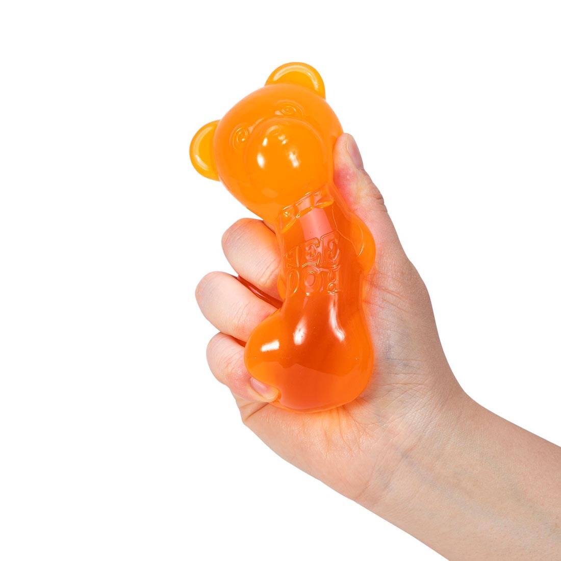 hand squishing an orange Nee Doh Gummy Bear