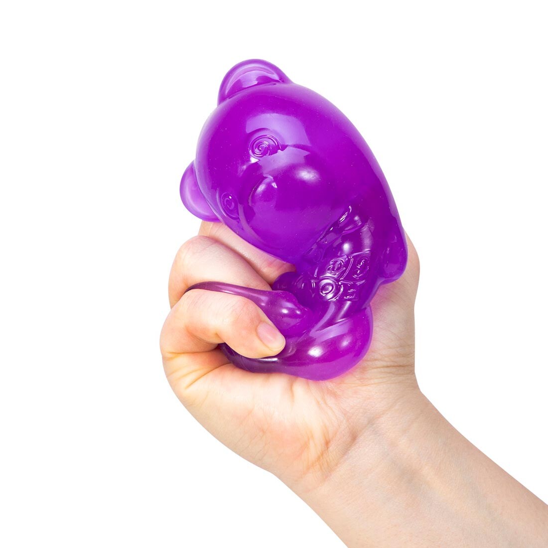 hand squishing a purple Nee Doh Gummy Bear