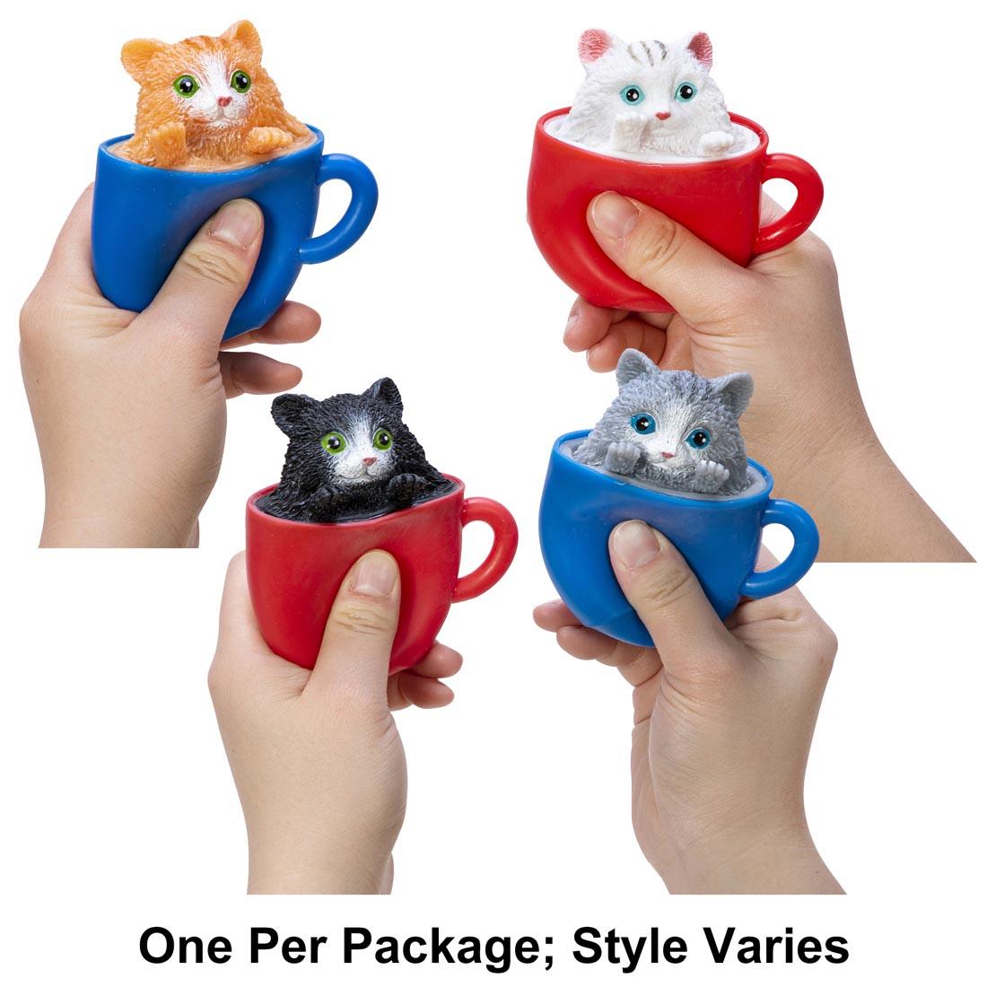 hands holding 4 different Pop-A-Chino Kitties Squishy Toy By Schylling Toys with text One Per Package; Style Varies