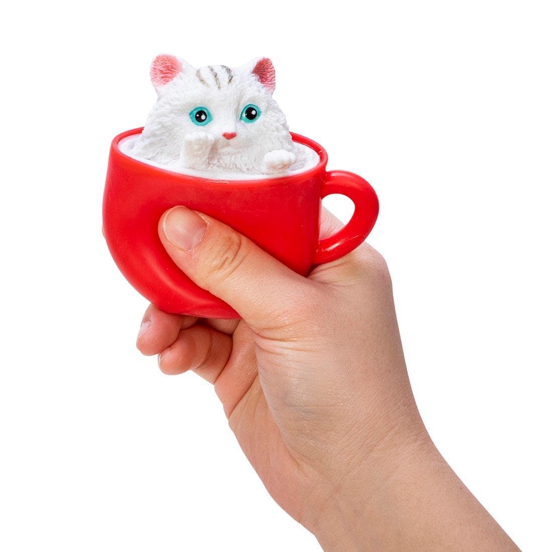 hand squeezing a Pop-A-Chino Kitties Squishy Toy By Schylling Toys