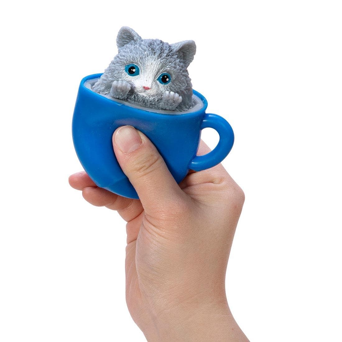 hand squeezing a Pop-A-Chino Kitties Squishy Toy By Schylling Toys