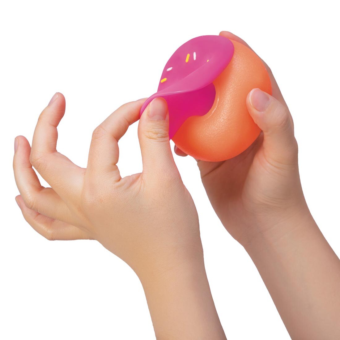 two hands pulling on a Nee Doh Dohnut