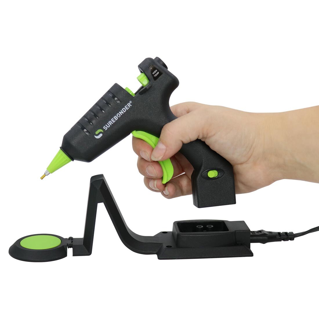 Hand taking the Surebonder High Temperature Cordless Detailer Mini Glue Gun off of its stand