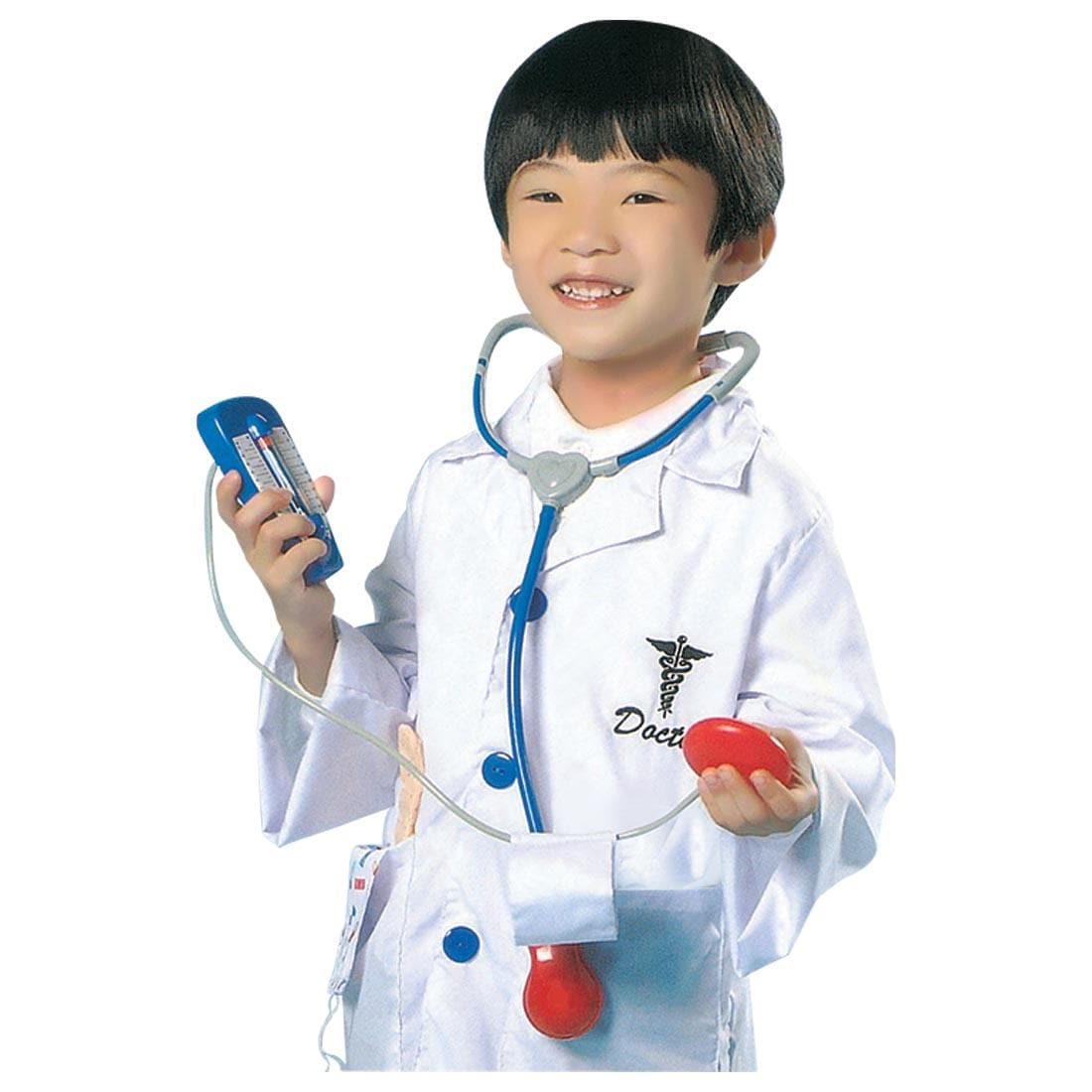 child dressed in the Doctor Role Play Costume, holding the toy blood pressure monitor
