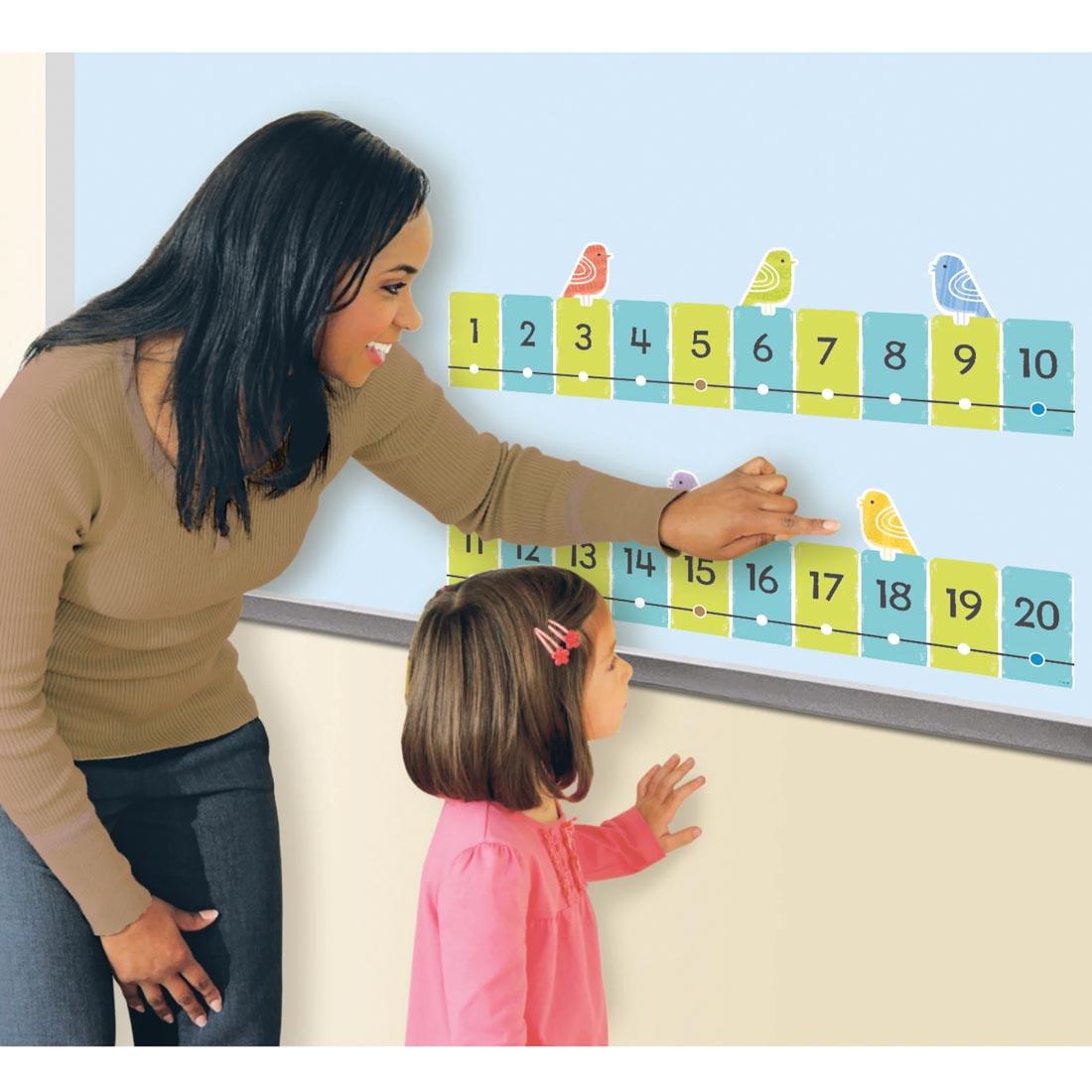 adult and child using pieces of the On the Fence Number Line -20 to 120 Learning Set from the Good To Grow collection by TREND