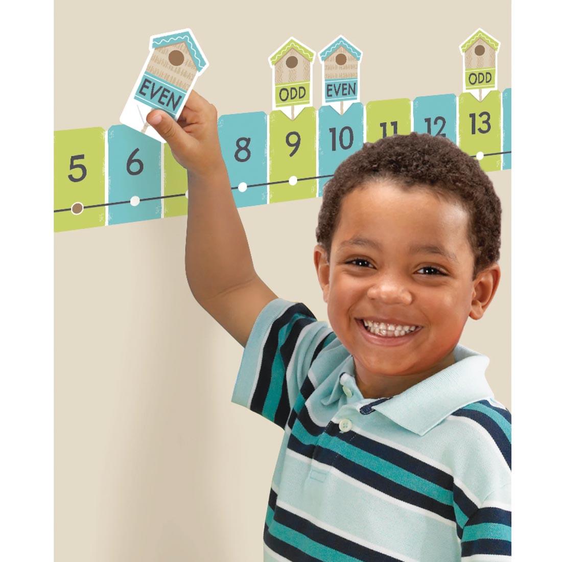 child using pieces of the On the Fence Number Line -20 to 120 Learning Set from the Good To Grow collection by TREND