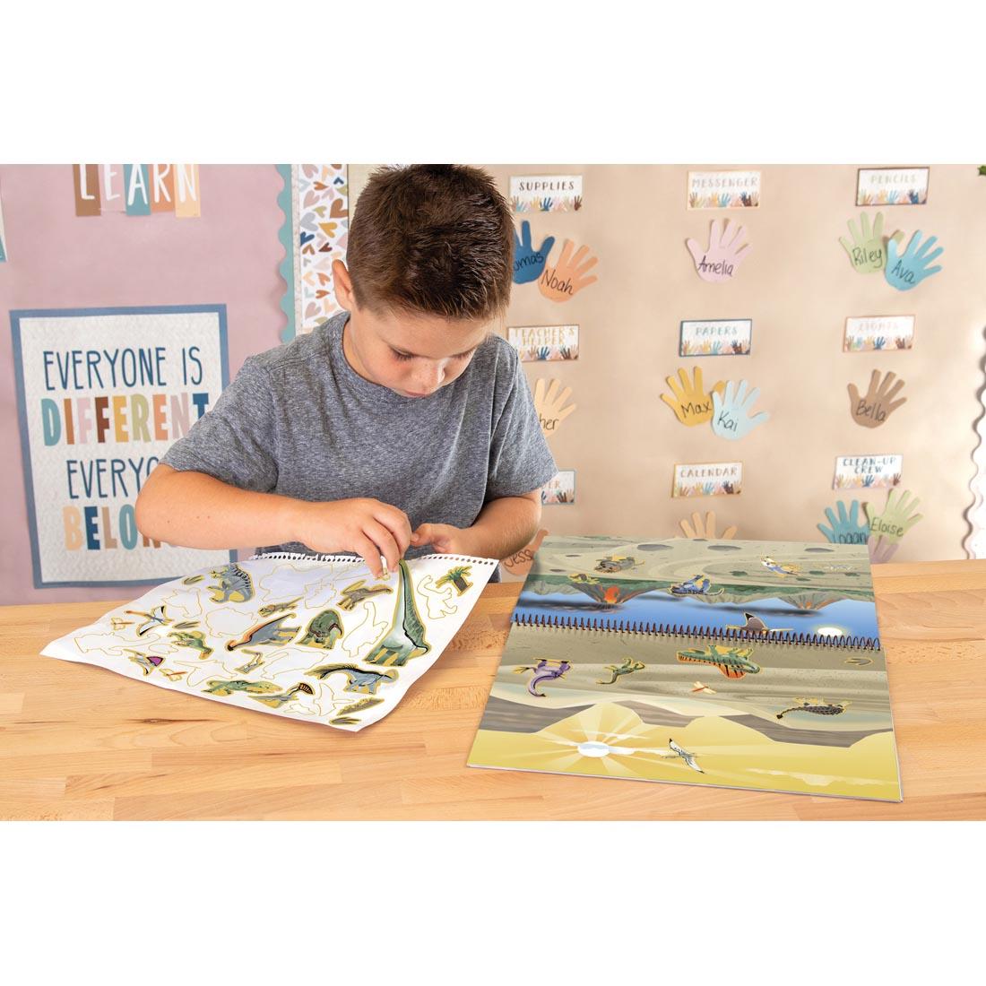 child playing with the Dinosaurs And Prehistoric Animals Reusable Sticker Pad By Teacher Created Resources