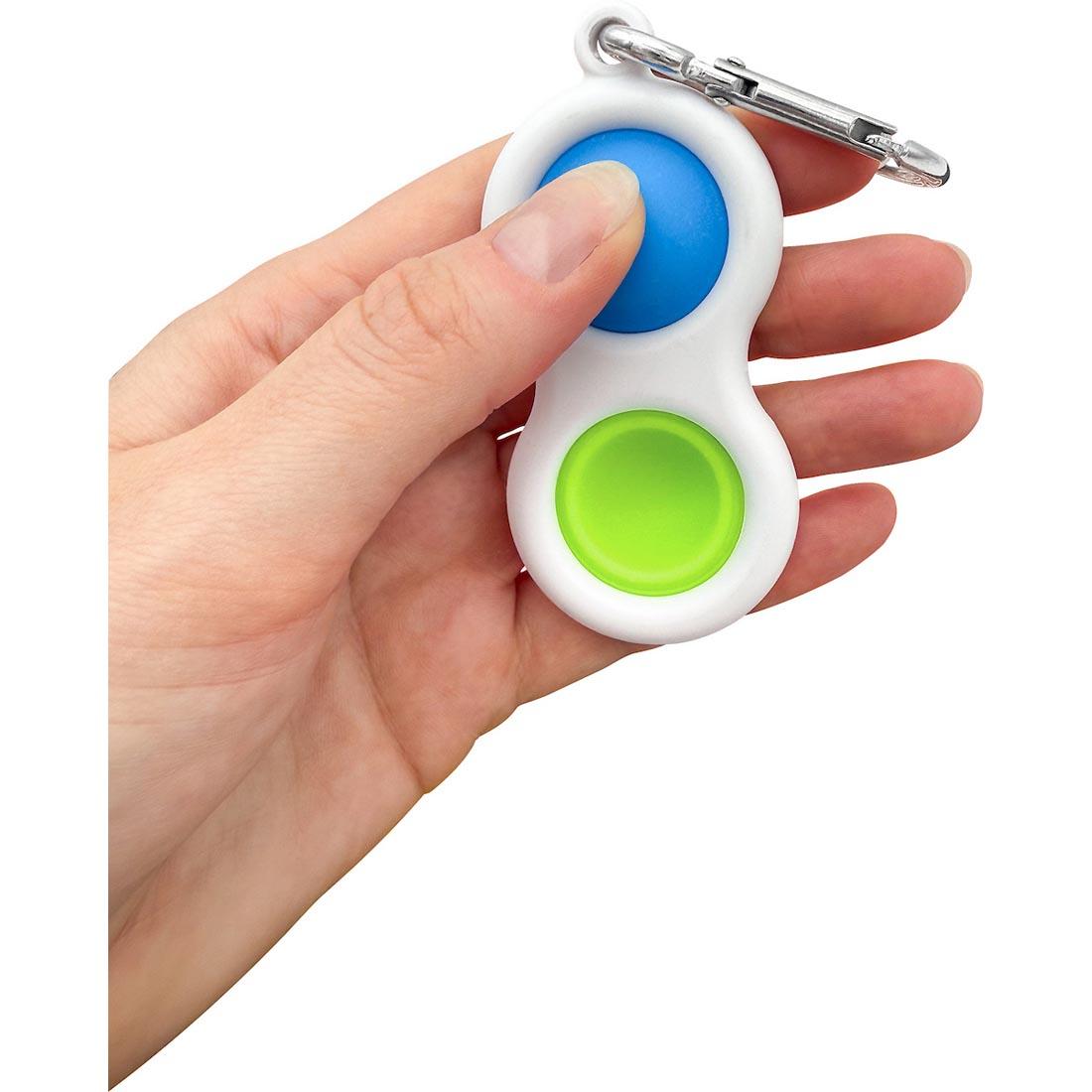 hand holding a Blue And Green Fidget Popper Keychain By Teacher Created Resources