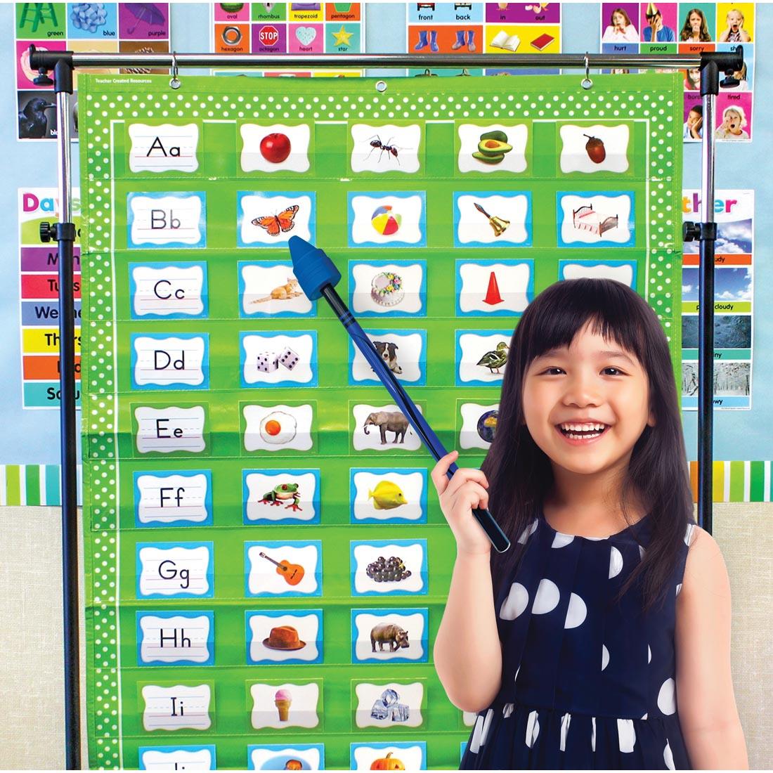 child standing in front of a pocket chart using the Blue Crayon Hand Pointer By Teacher Created Resources