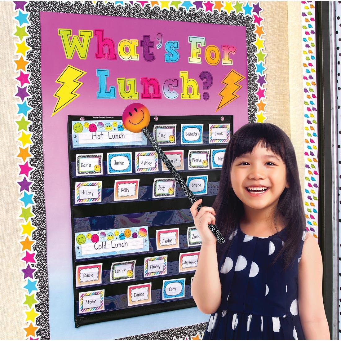 child standing in front of a pocket chart using a Smiley Face Hand Pointer By Teacher Created Resources