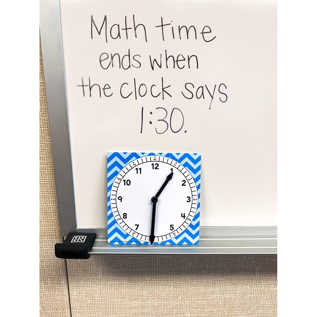 a Teacher Created Resources Clock on a whiteboard with text Math time ends when the clock says 1:30