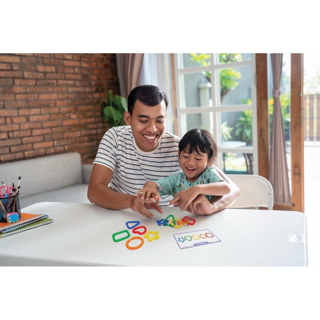 child and adult playing with Linking Shapes By Teacher Created Resources