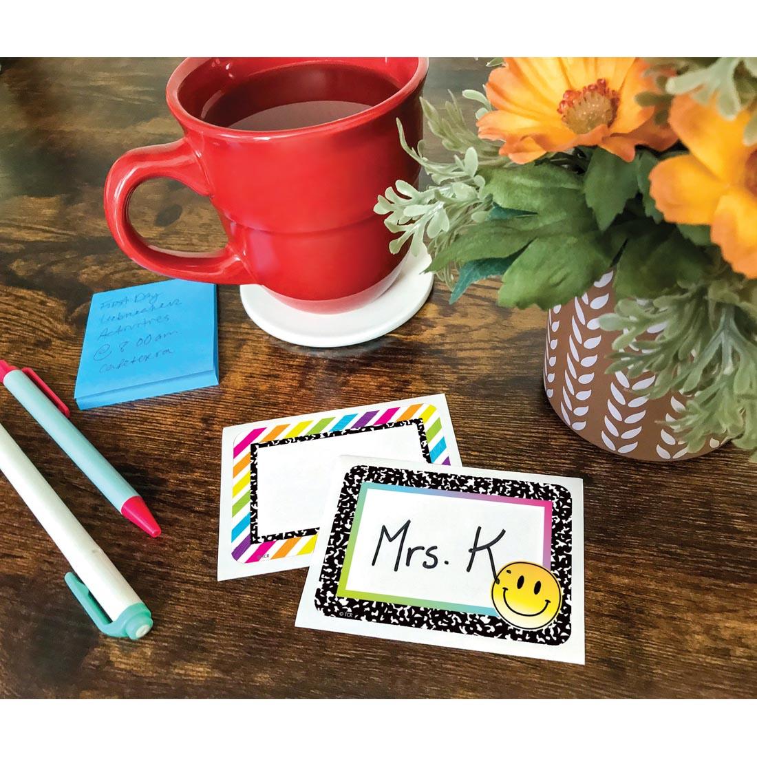 Two Name Tags/Labels from the Brights 4Ever collection by Teacher Created Resources laying on a desk