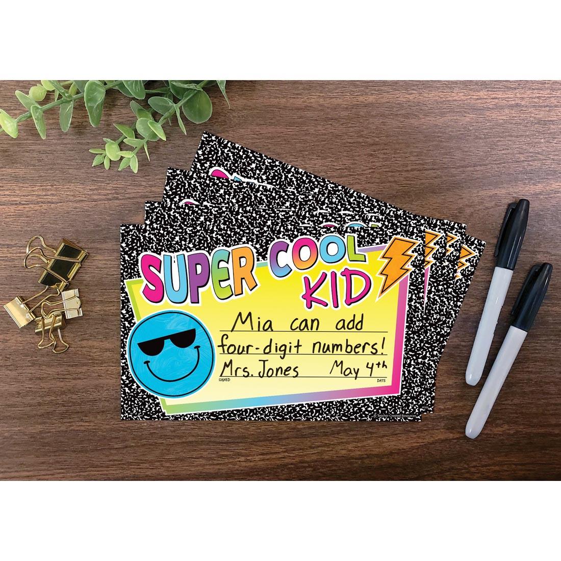 example of a completed Super Cool Kid Award from the Brights 4Ever collection by Teacher Created Resources laying on a desk