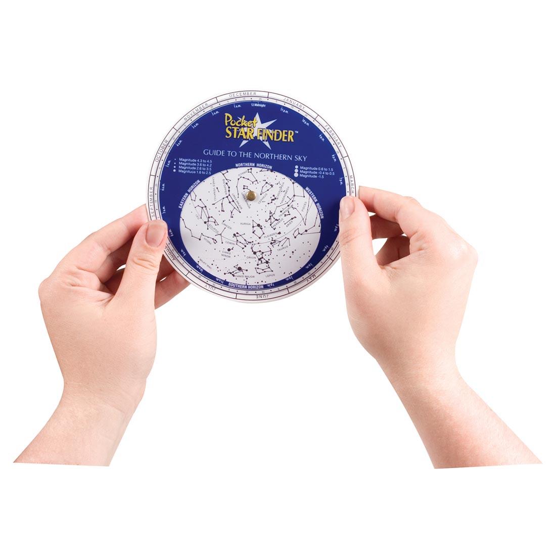 Two hands holding up the Toysmith Pocket Star Finder