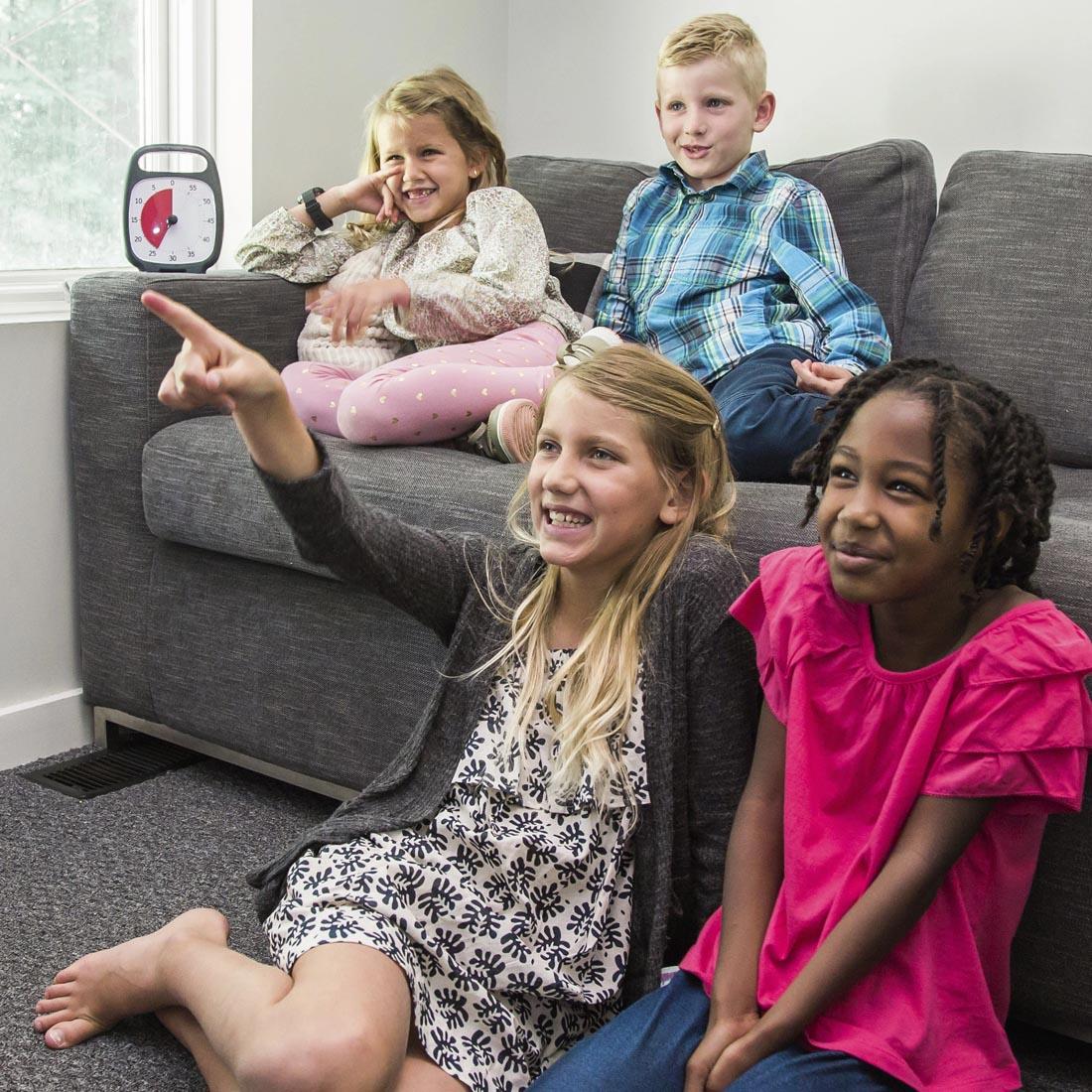 Children appearing to watch TV next to the Time Timer PLUS 60-Minute Timer