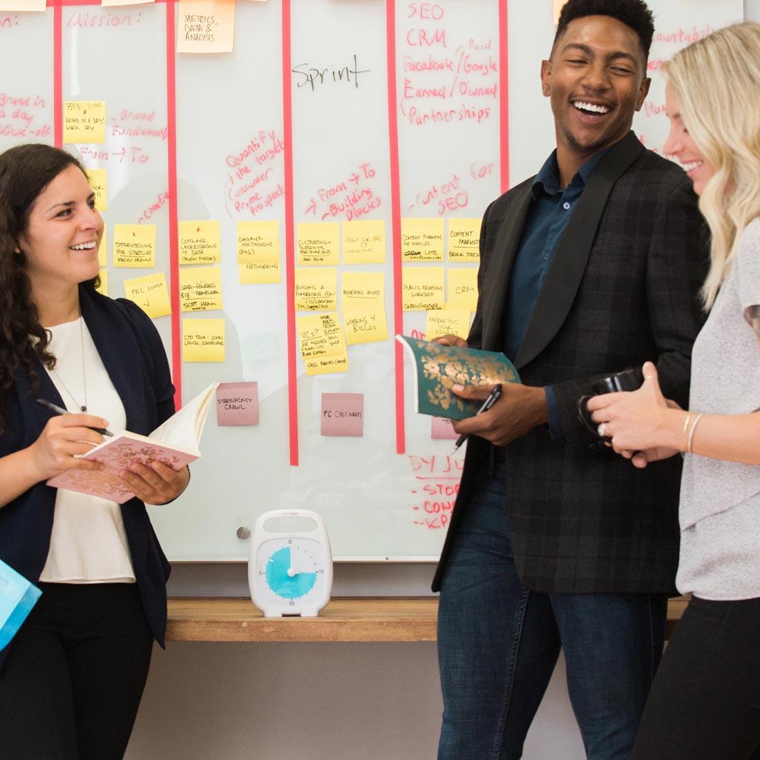 Adults in an office setting next to the Time Timer PLUS 20-Minute Timer