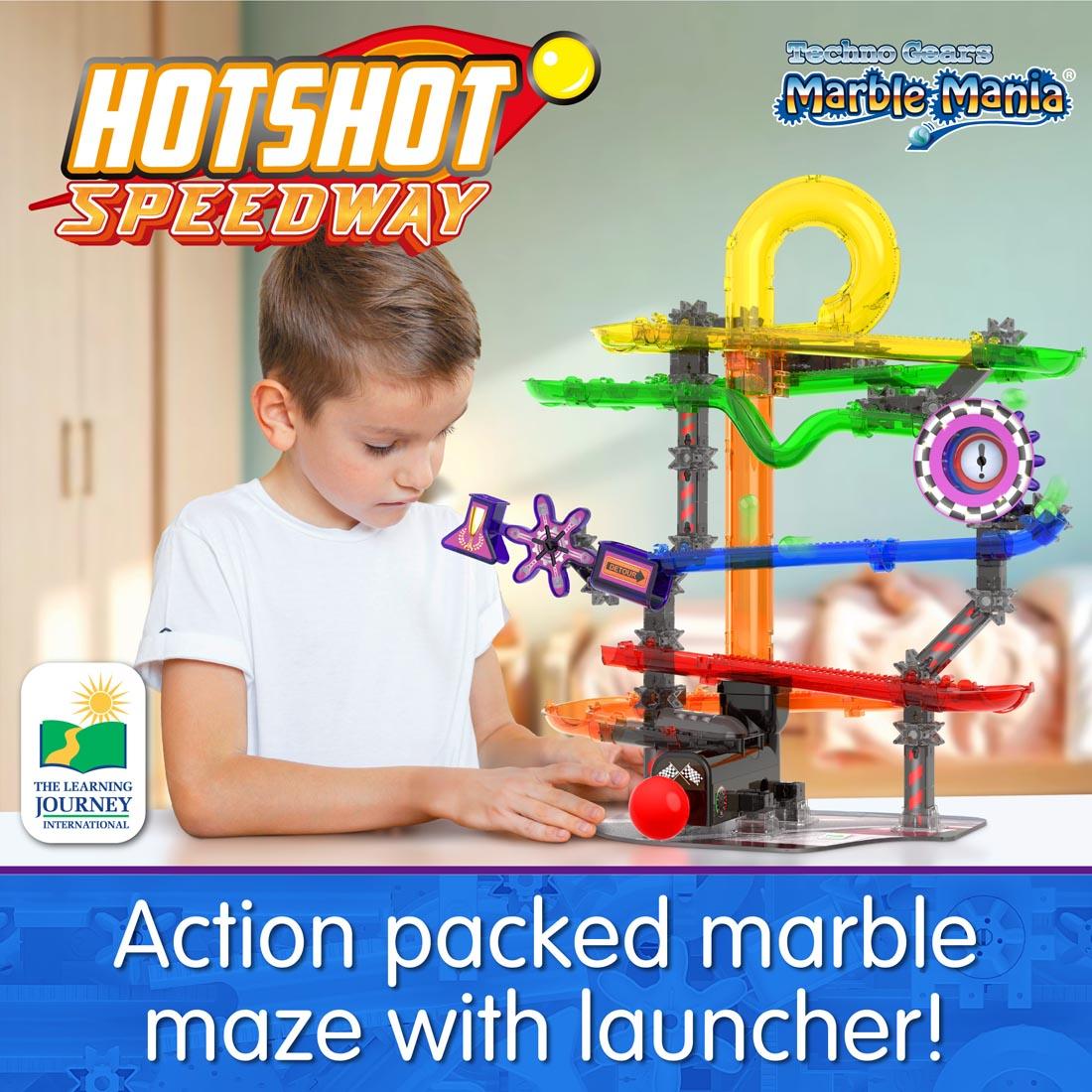 boy playing with marble run, with the words: Action packed marble maze with launcher!