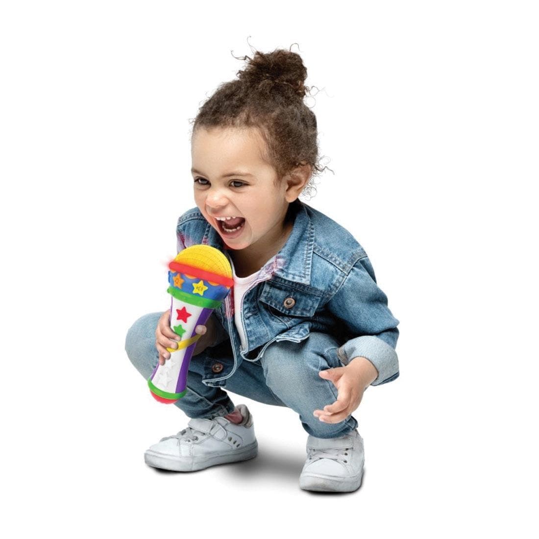 squatting child using the Sing A Long Microphone By The Learning Journey