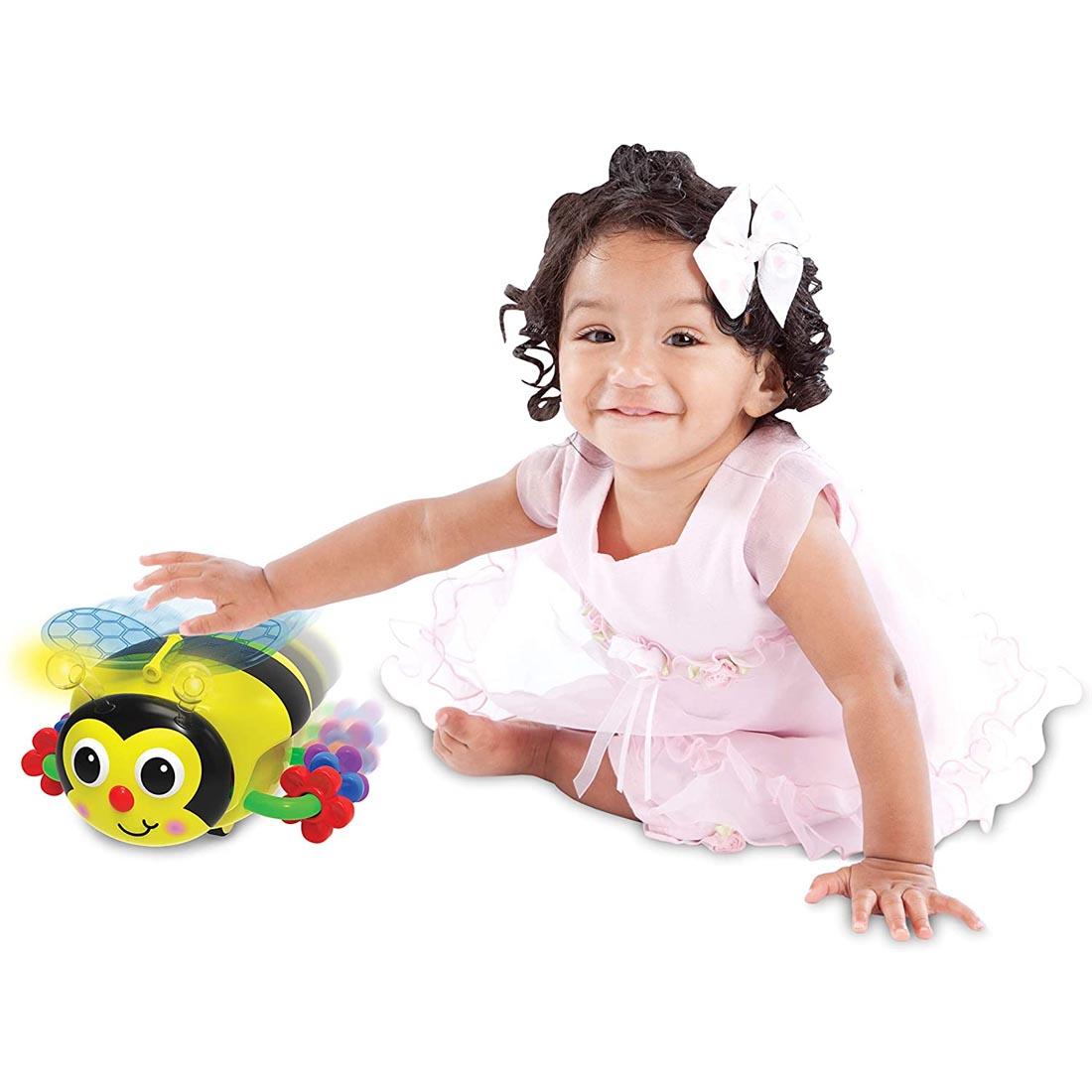 Child sitting next to the Crawl About Bee By The Learning Journey