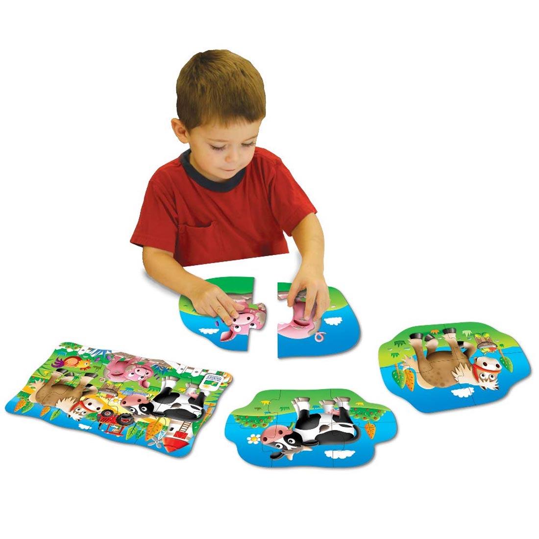 Child playing with the My First Puzzles 4-In-A-Box Farm Puzzles Set By The Learning Journey