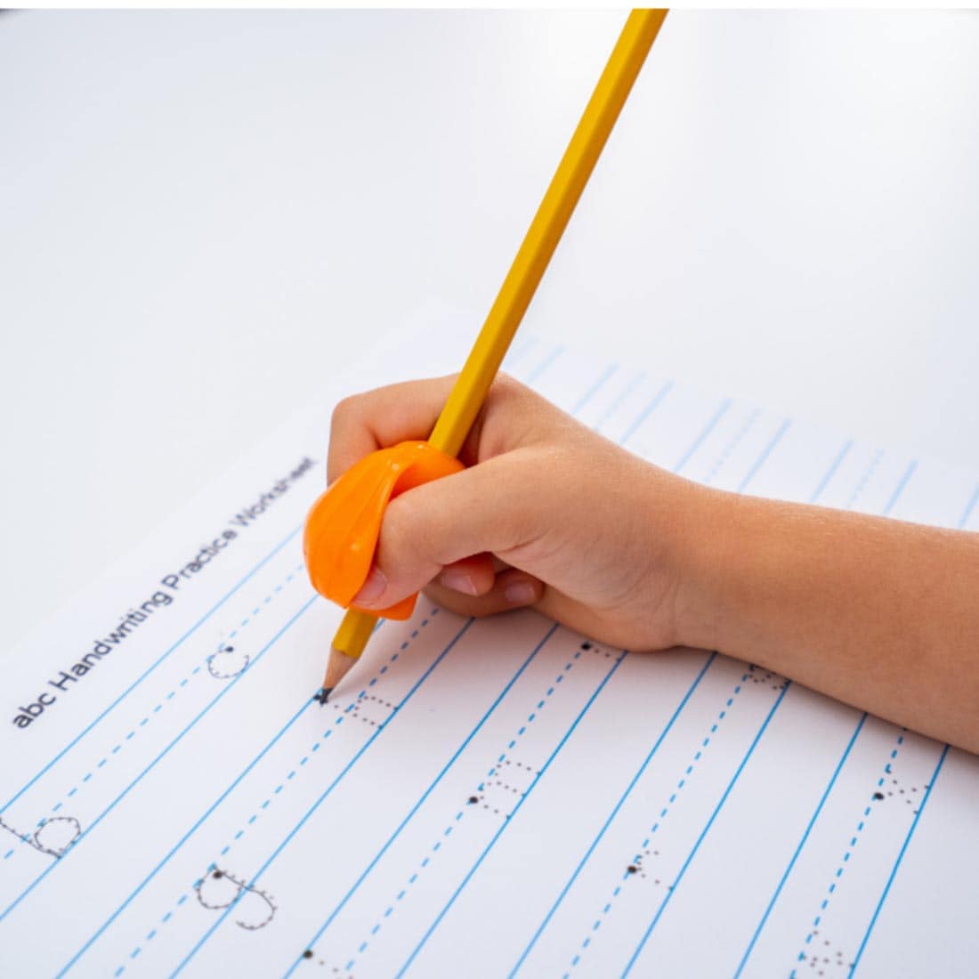 hand tracing letters on a page, using a pencil with The Pencil Grip Crossover Grip Classic