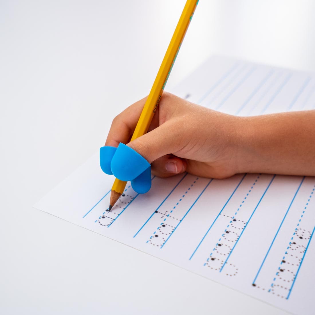 hand tracing letters on a page, using a pencil with The Claw Grip, size medium