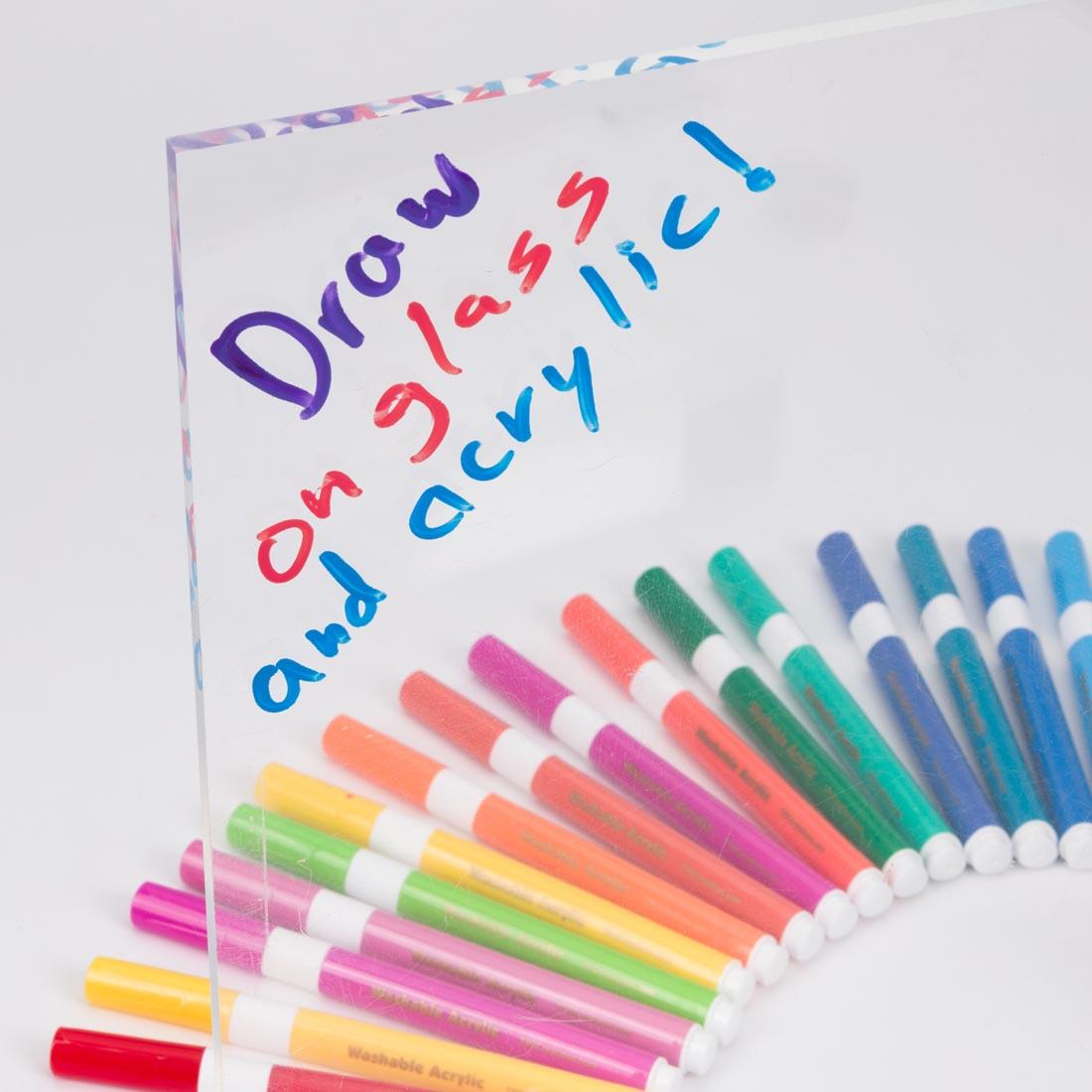 an array of Magic Stix Washable Acrylic Markers and glass with the words Draws on glass and acrylic! drawn on