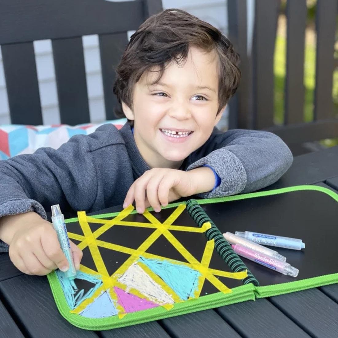 child using the Sea Life Daily Doodler Reusable Activity Book With Wonder Stix