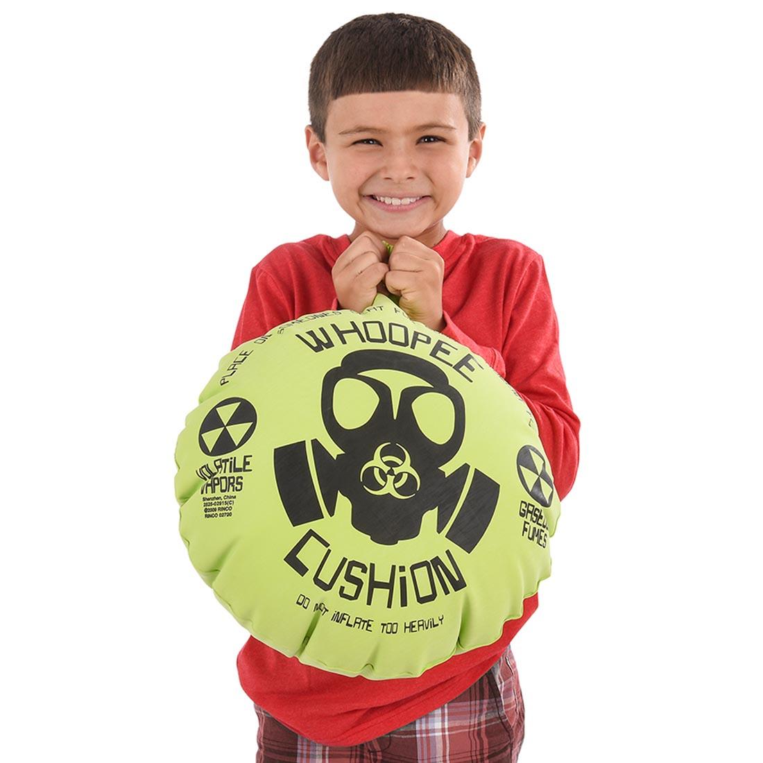 child holding the inflated Mega Whoopee Cushion